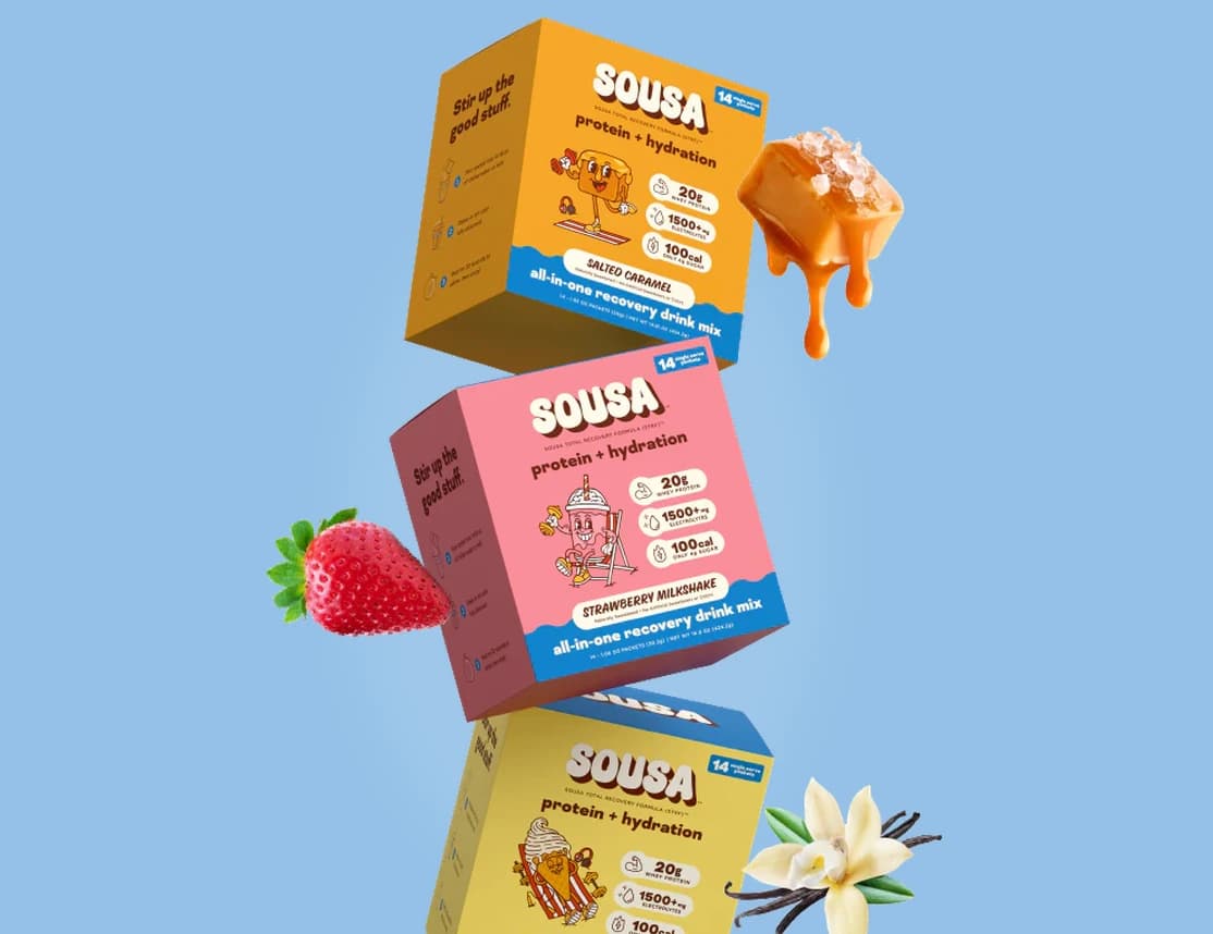 Three Sousa product boxes with fruit against a light blue background